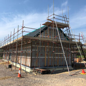 A building surrounded by scaffolding on a building site.