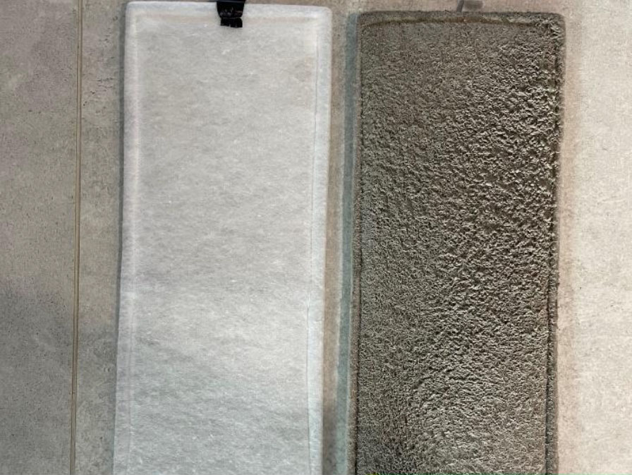 A close up of a clean, white new and dirty and grey used filter next to each other.