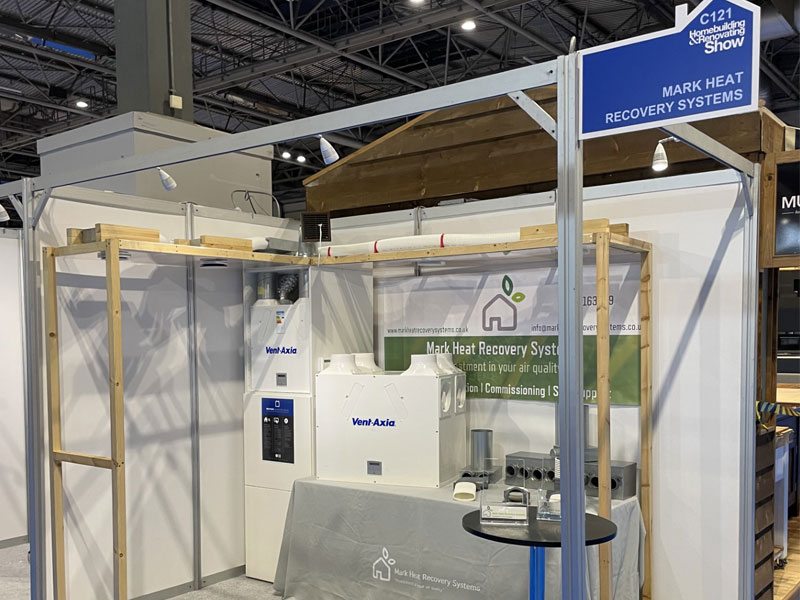 A stand displaying Mark Heat Recovery Systems business implementing ventilation systems including the "Vent-Axia" in a warehouse.